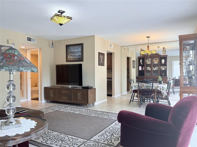 11764 Raintree Dr Unit 0, Temple Terrace, FL 33617 - living room with light tile patterned floors, baseboards, and a textured ceiling