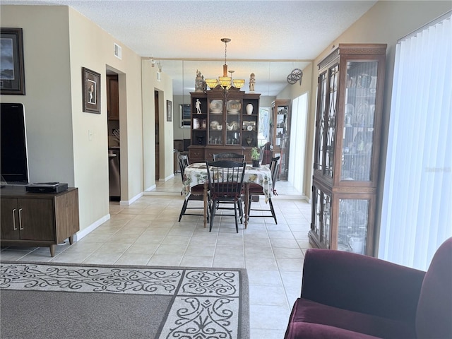 11764 Raintree Dr Unit 0, Temple Terrace, FL 33617 - dining room with a chandelier, light tile patterned floors, a textured ceiling, and baseboards