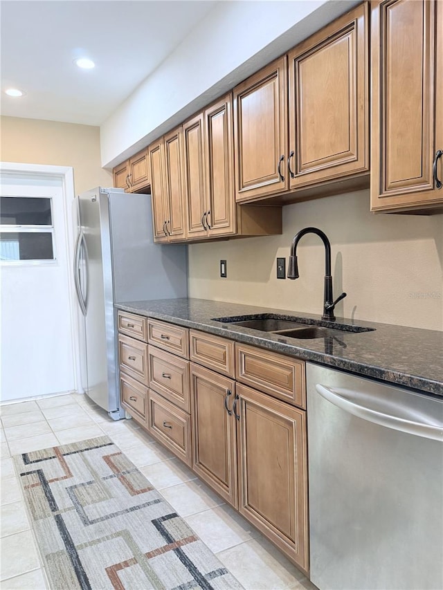 11764 Raintree Dr Unit 0, Temple Terrace, FL 33617 - kitchen featuring appliances with stainless steel finishes, a sink, dark stone counters, recessed lighting, and light tile patterned floors