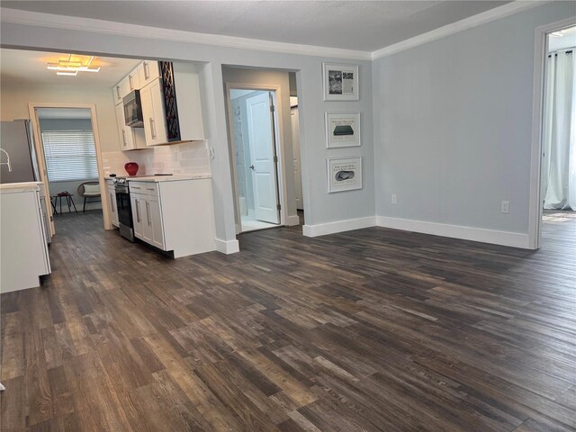3008 E 38th Ave, Tampa, FL 33610 - kitchen featuring electric range, freestanding refrigerator, ornamental molding, black microwave, and dark wood finished floors