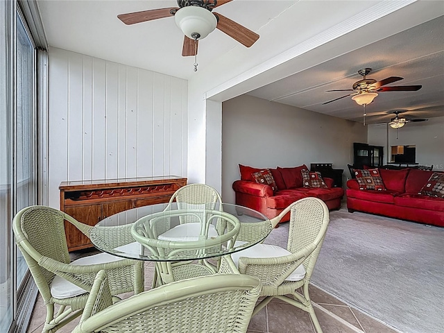 1 Boca Ciega Point Blvd Unit 215, Saint Petersburg, FL 33708 - tiled dining area featuring a ceiling fan and carpet flooring
