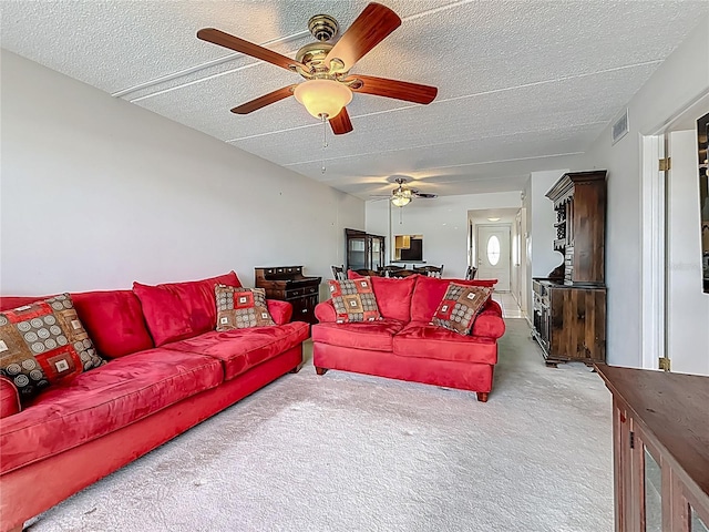 1 Boca Ciega Point Blvd Unit 215, Saint Petersburg, FL 33708 - carpeted living room featuring ceiling fan and a textured ceiling