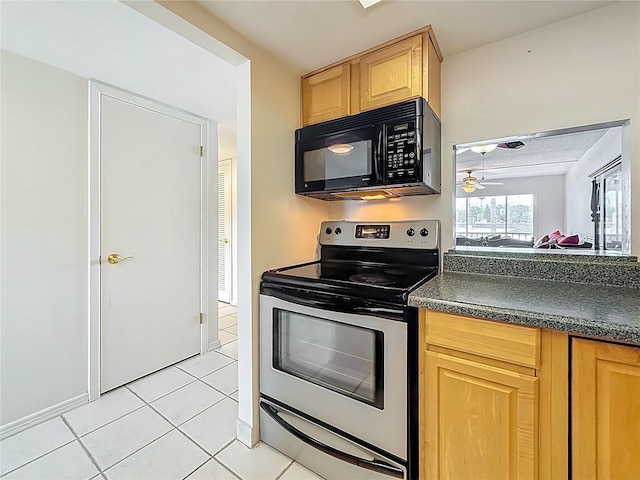 1 Boca Ciega Point Blvd Unit 215, Saint Petersburg, FL 33708 - kitchen with electric stove, black microwave, light brown cabinetry, dark countertops, and ceiling fan