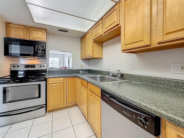 1 Boca Ciega Point Blvd Unit 215, Saint Petersburg, FL 33708 - kitchen with stainless steel appliances, a sink, dark countertops, and light tile patterned floors