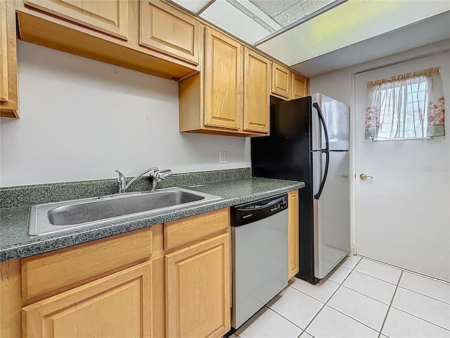1 Boca Ciega Point Blvd Unit 215, Saint Petersburg, FL 33708 - kitchen with appliances with stainless steel finishes, a sink, dark countertops, light tile patterned floors, and light brown cabinetry