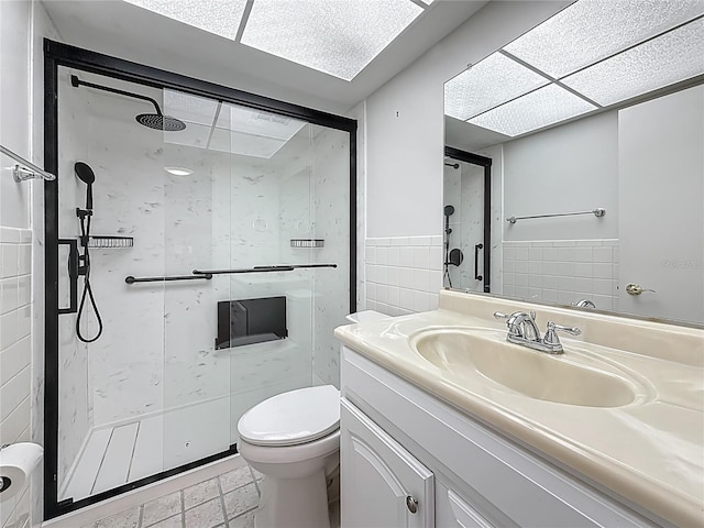 1 Boca Ciega Point Blvd Unit 215, Saint Petersburg, FL 33708 - bathroom featuring a shower stall, tile walls, toilet, vanity, and a wainscoted wall