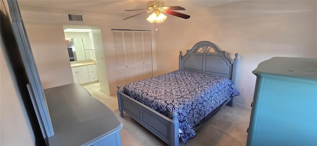 1 Boca Ciega Point Blvd Unit 215, Saint Petersburg, FL 33708 - bedroom featuring light carpet, a closet, a ceiling fan, connected bathroom, and baseboards
