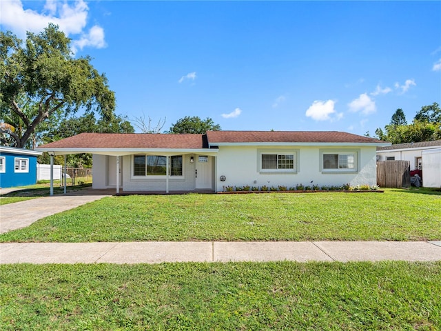 302 Patty Dr, Oldsmar, FL 34677 - ranch-style house featuring concrete driveway, stucco siding, and a carport