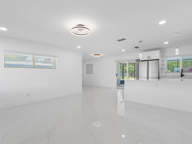 302 Patty Dr, Oldsmar, FL 34677 - empty room with light marble finish floors, recessed lighting, and plenty of natural light