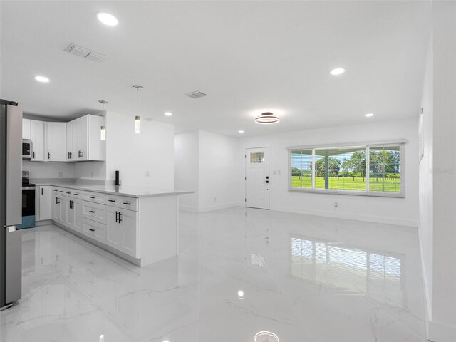 302 Patty Dr, Oldsmar, FL 34677 - kitchen featuring a peninsula, light marble finish floors, recessed lighting, stainless steel appliances, and white cabinetry
