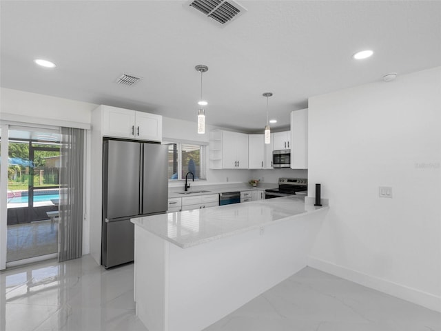 302 Patty Dr, Oldsmar, FL 34677 - kitchen featuring appliances with stainless steel finishes, recessed lighting, healthy amount of natural light, a peninsula, and open shelves