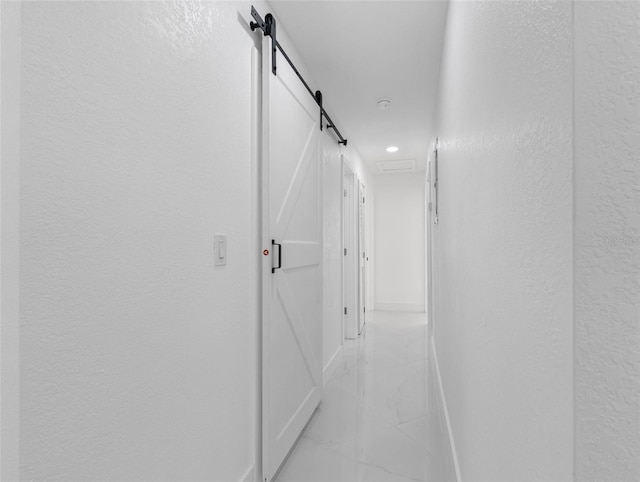 302 Patty Dr, Oldsmar, FL 34677 - corridor featuring light marble finish floors, a textured wall, recessed lighting, and a barn door