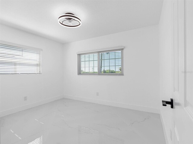 302 Patty Dr, Oldsmar, FL 34677 - unfurnished room featuring marble finish flooring and baseboards