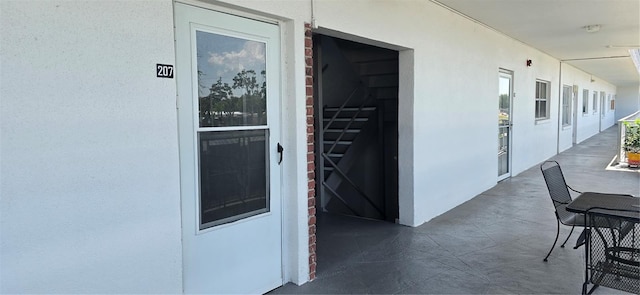 property entrance with stucco siding