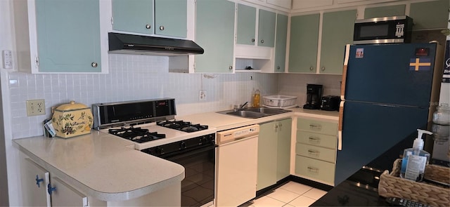 kitchen with stainless steel microwave, freestanding refrigerator, gas range oven, under cabinet range hood, and dishwasher