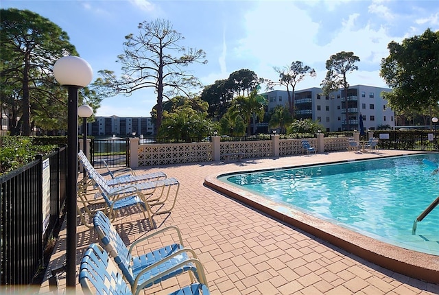 community pool with a patio area