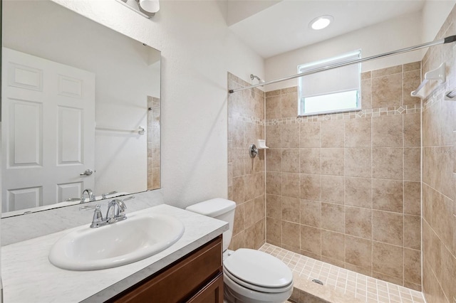 full bath with toilet, vanity, and a shower stall