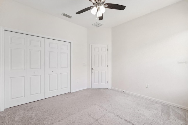 unfurnished bedroom featuring carpet flooring, a closet, baseboards, and a ceiling fan