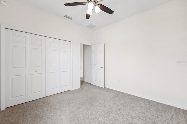 unfurnished bedroom featuring carpet flooring, a closet, baseboards, and ceiling fan