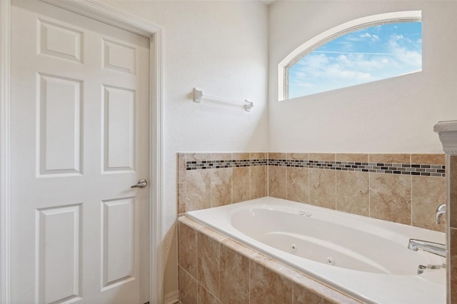 bathroom with a tub with jets