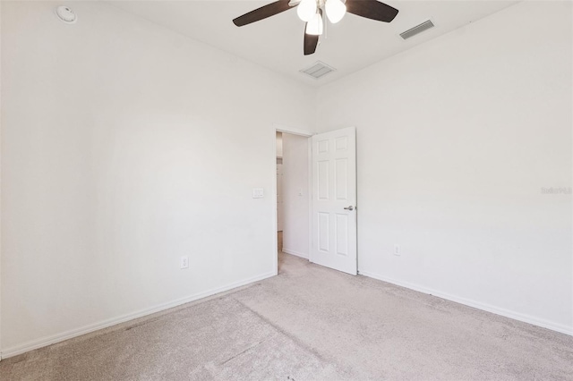 empty room with a ceiling fan, carpet, and baseboards