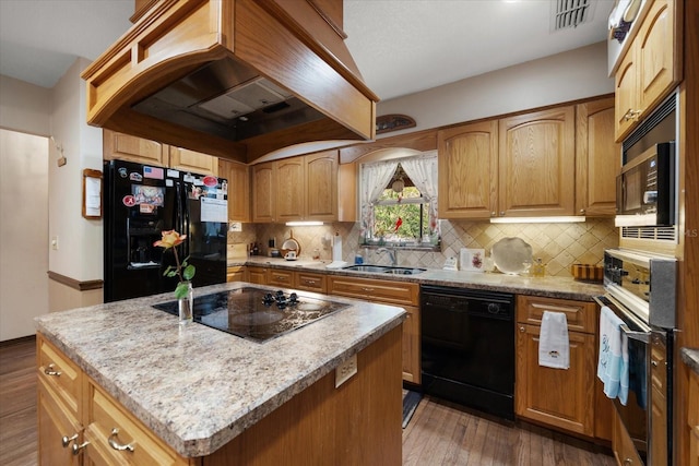 1799 Dixie Hwy, Tarpon Springs, FL 34689 - kitchen with black appliances, custom exhaust hood, a sink, dark wood finished floors, and decorative backsplash