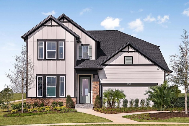 17020 Cercis Loop, Clermont, FL 34711 - view of front of home with a shingled roof, stone siding, board and batten siding, a garage, and a front yard