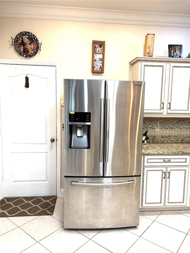 19420 Haskell Pl, Land O Lakes, FL 34638 - kitchen with stainless steel refrigerator with ice dispenser, crown molding, light tile patterned flooring, light stone countertops, and decorative backsplash