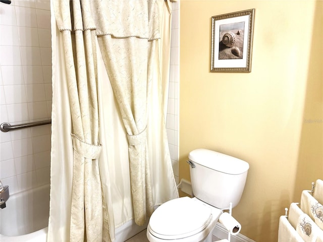 19420 Haskell Pl, Land O Lakes, FL 34638 - bathroom featuring baseboards, toilet, and shower / bath combination with curtain