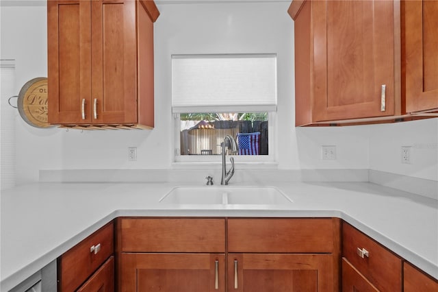 905 W Fribley St, Tampa, FL 33603 - kitchen with a sink, light countertops, and brown cabinets