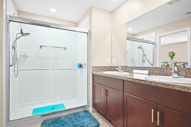 742 8th St NW, Ruskin, FL 33570 - bathroom with a stall shower, double vanity, and recessed lighting
