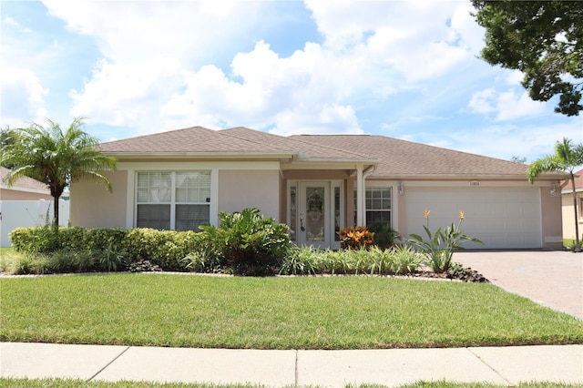 11014 Peking Pl, Tampa, FL 33624 - view of front facade with a garage, concrete driveway, stucco siding, and a front lawn