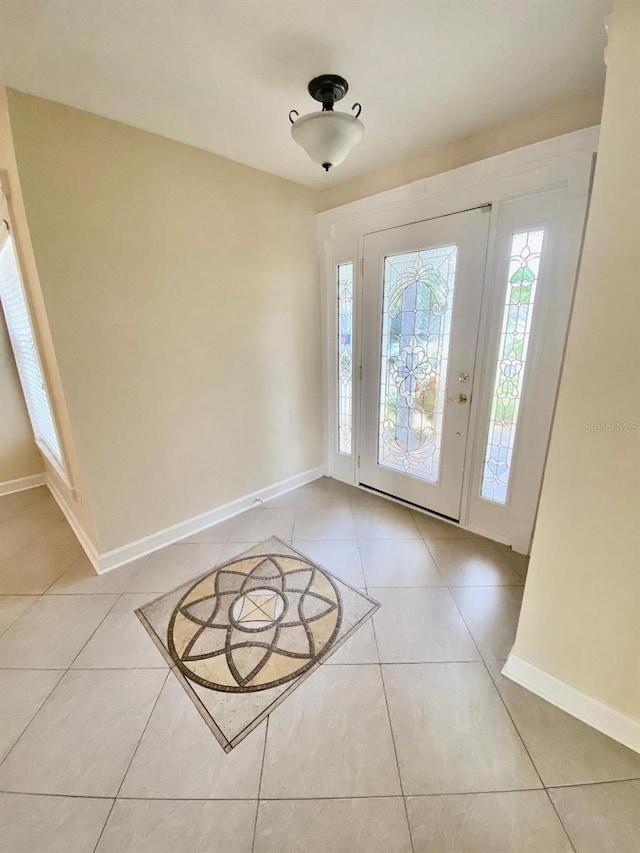 11014 Peking Pl, Tampa, FL 33624 - foyer featuring light tile patterned floors and baseboards