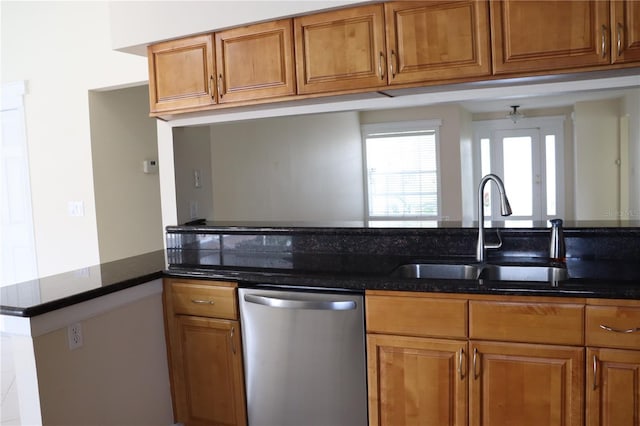 11014 Peking Pl, Tampa, FL 33624 - kitchen featuring stainless steel dishwasher, a sink, brown cabinets, and dark stone countertops