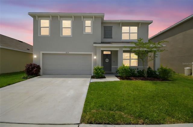 33524 Elm Hill Br, Wesley Chapel, FL 33545 - view of front facade with stucco siding, an attached garage, a front lawn, and concrete driveway