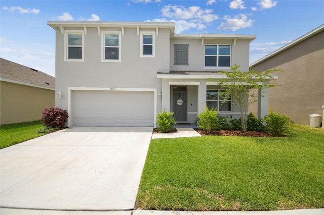 33524 Elm Hill Br, Wesley Chapel, FL 33545 - view of front facade featuring stucco siding, a front yard, driveway, and a garage