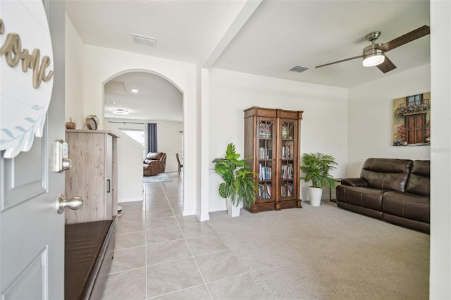 33524 Elm Hill Br, Wesley Chapel, FL 33545 - living area with arched walkways, light tile patterned floors, and a ceiling fan