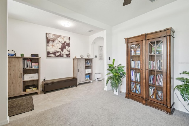 33524 Elm Hill Br, Wesley Chapel, FL 33545 - sitting room featuring arched walkways, carpet, a ceiling fan, and baseboards