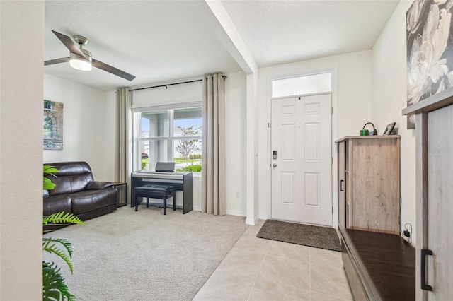 33524 Elm Hill Br, Wesley Chapel, FL 33545 - entryway with ceiling fan, light tile patterned flooring, light colored carpet, and baseboards