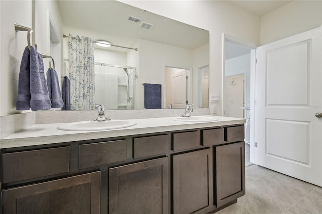 33524 Elm Hill Br, Wesley Chapel, FL 33545 - bathroom featuring a shower stall, tile patterned flooring, and double vanity