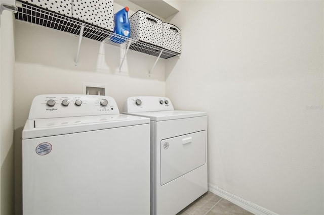 33524 Elm Hill Br, Wesley Chapel, FL 33545 - laundry room featuring separate washer and dryer, light tile patterned flooring, and baseboards