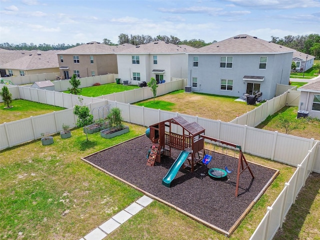 33524 Elm Hill Br, Wesley Chapel, FL 33545 - view of jungle gym featuring a vegetable garden, central AC, and a residential view