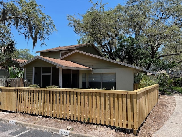 14725 Morning Dr, Lutz, FL 33559 - view of front facade featuring a sunroom and roof with shingles