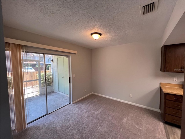 14725 Morning Dr, Lutz, FL 33559 - unfurnished dining area featuring carpet, baseboards, and a textured ceiling