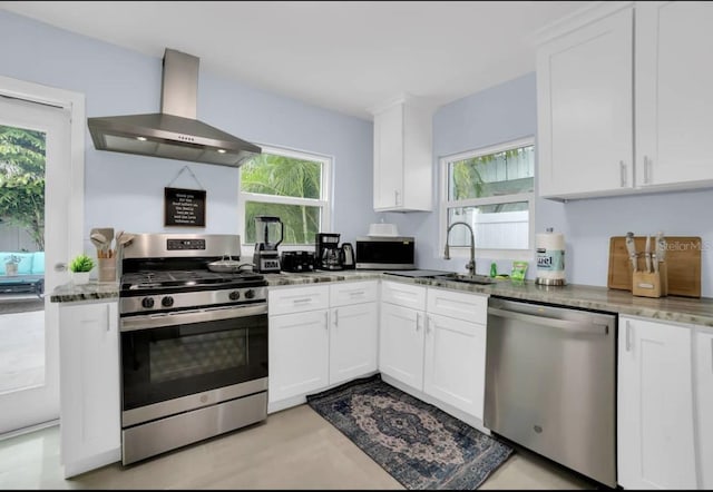 1210 Bay Palm Blvd, Indian Rocks Beach, FL 33785 - kitchen featuring stainless steel appliances, ventilation hood, stone countertops, and healthy amount of natural light