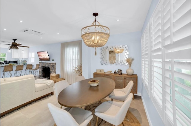 1210 Bay Palm Blvd, Indian Rocks Beach, FL 33785 - dining space with a chandelier, a stone fireplace, recessed lighting, a ceiling fan, and baseboards