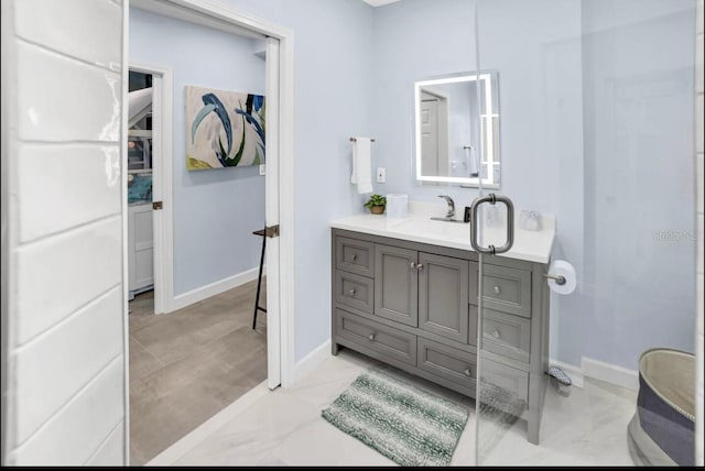 1210 Bay Palm Blvd, Indian Rocks Beach, FL 33785 - full bathroom with vanity, baseboards, and marble finish flooring