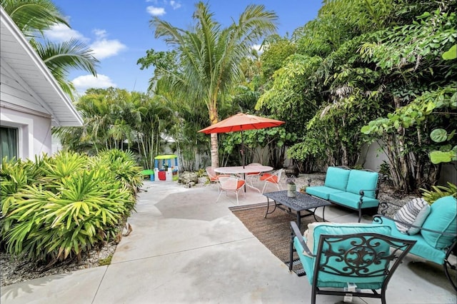 1210 Bay Palm Blvd, Indian Rocks Beach, FL 33785 - fenced backyard featuring a patio, an outdoor hangout area, and outdoor dining space