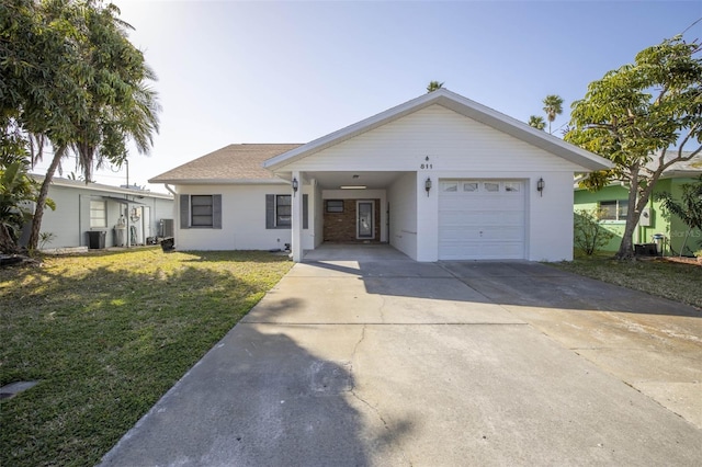 811 Bay Point Dr, Madeira Beach, FL 33708 - ranch-style house featuring a front yard, cooling unit, concrete driveway, and a carport