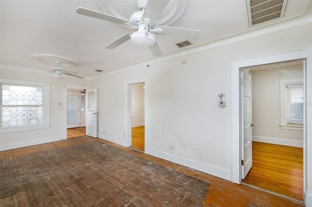 3108 Dupont St S, Gulfport, FL 33707 - unfurnished room with crown molding, a ceiling fan, wood-type flooring, and baseboards